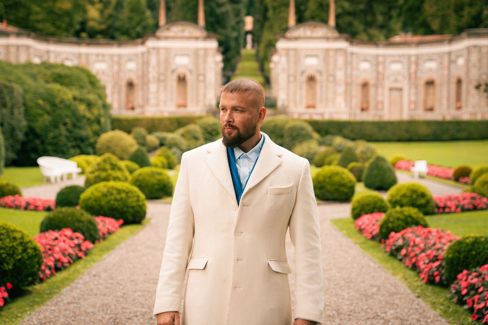 Felix Blume in a white coat in a formal garden